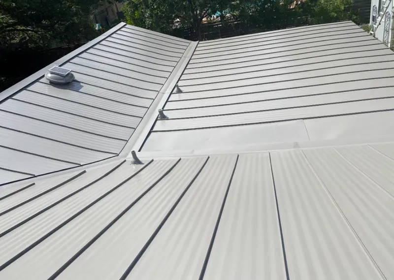 Solar attic fan installed on a metal roof for Roof Ventilation in Whitefish
